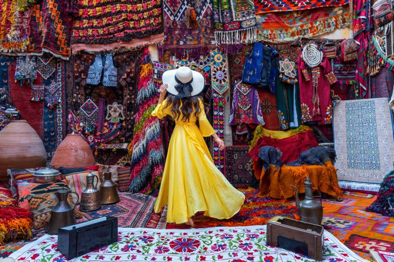 Beautiful girl at traditional carpet shop in Goreme city, Cappadocia in Türkiye.